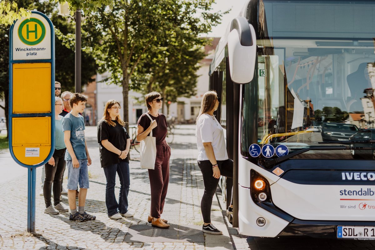 Leute stehen für Bus an